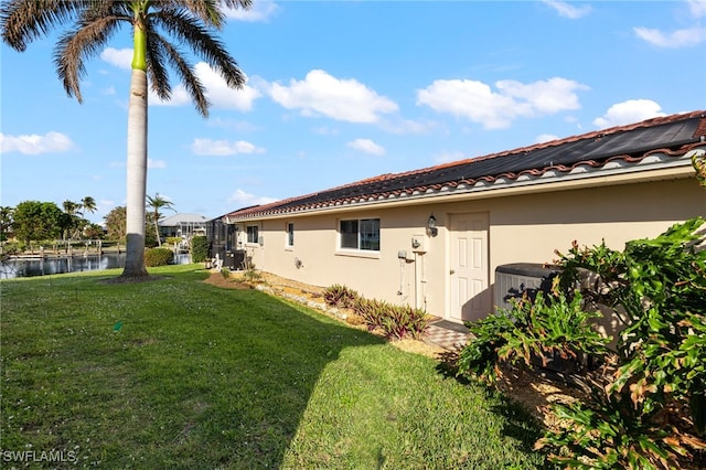 view of side of property featuring a yard and a water view