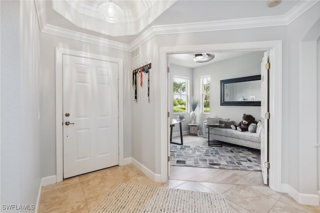 tiled entryway featuring crown molding