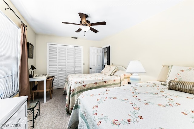 carpeted bedroom with multiple windows, a closet, and ceiling fan