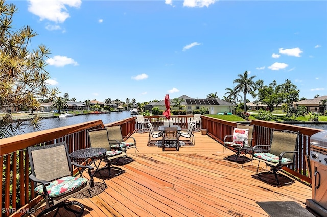 wooden terrace featuring a water view