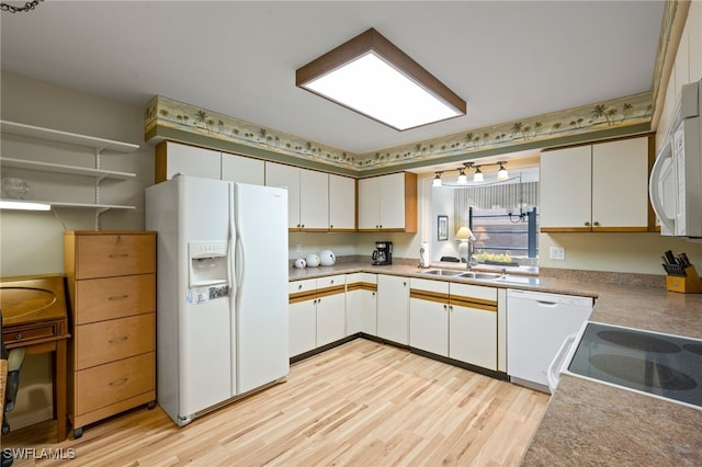 kitchen with white cabinetry, sink, light hardwood / wood-style flooring, and white appliances