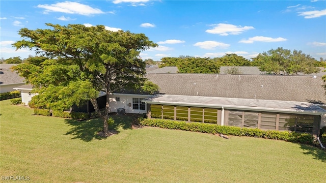 back of house with a lawn