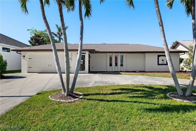 ranch-style home featuring a garage and a front yard