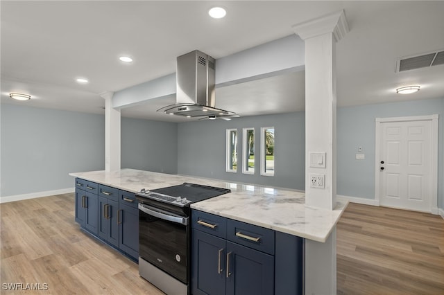 kitchen with light stone countertops, light wood-type flooring, stainless steel range with electric cooktop, and wall chimney range hood