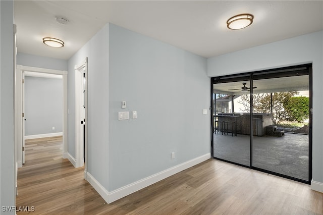 empty room featuring ceiling fan and light hardwood / wood-style floors