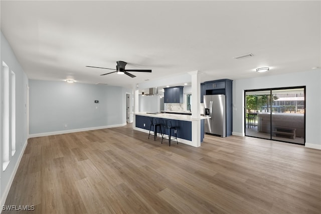 unfurnished living room featuring ceiling fan and light hardwood / wood-style floors