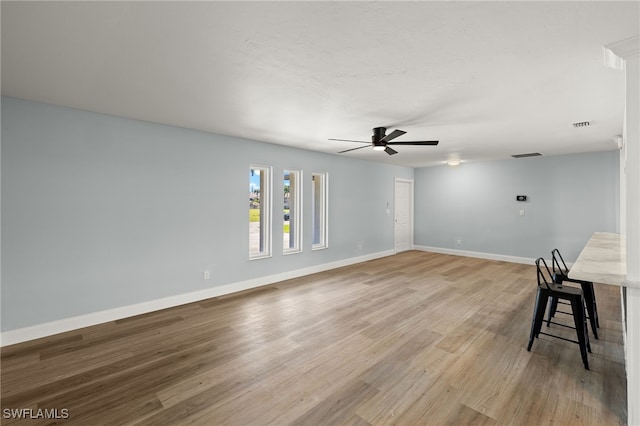 spare room with ceiling fan and light wood-type flooring