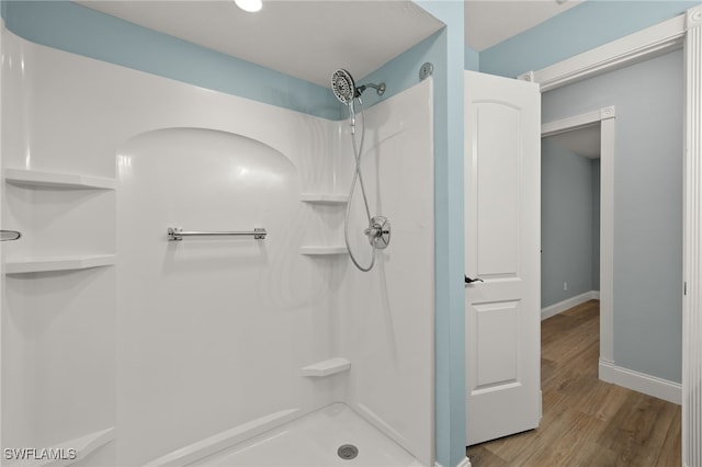 bathroom featuring a shower and hardwood / wood-style flooring