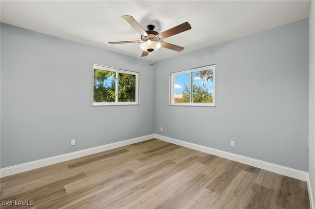 empty room with ceiling fan and light hardwood / wood-style floors