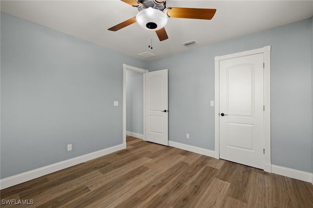 unfurnished bedroom featuring hardwood / wood-style floors and ceiling fan