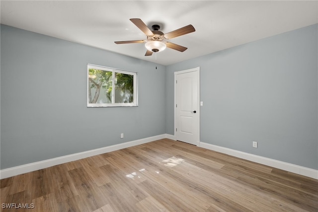 empty room with ceiling fan and light hardwood / wood-style floors