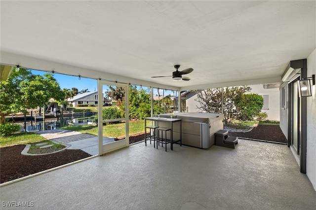 unfurnished sunroom with ceiling fan