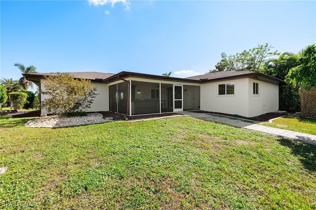 back of house featuring a sunroom and a yard