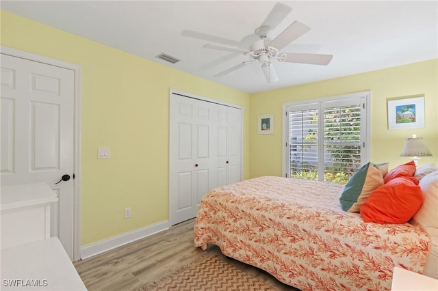 bedroom with ceiling fan, a closet, and light wood-type flooring