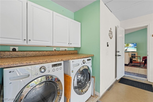 laundry room with cabinets and washer and clothes dryer