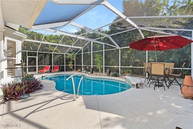 view of pool with a patio and a lanai