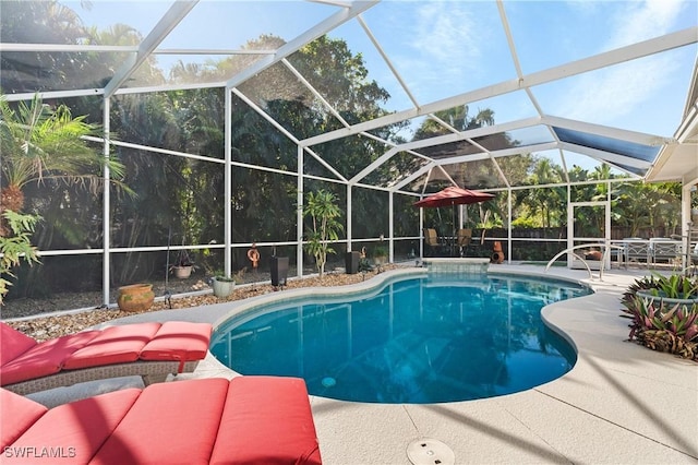 view of swimming pool with glass enclosure and a patio area