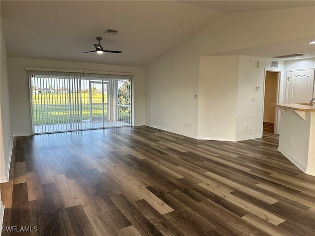 unfurnished living room with dark hardwood / wood-style floors, vaulted ceiling, ceiling fan, and sink