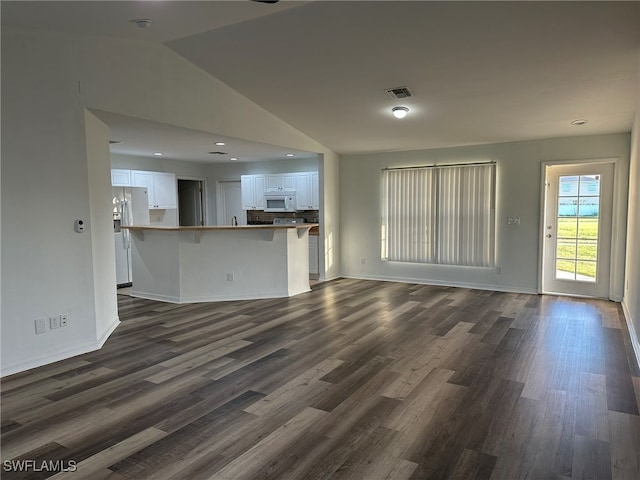 unfurnished living room with dark hardwood / wood-style flooring and lofted ceiling