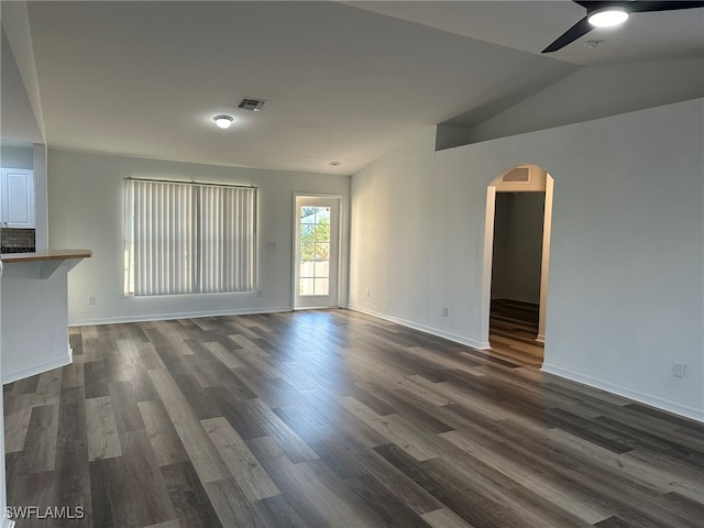 unfurnished living room featuring lofted ceiling, ceiling fan, and dark hardwood / wood-style floors