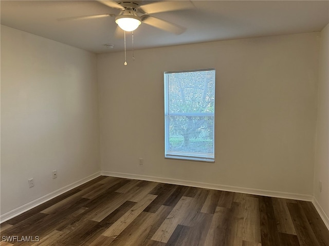 unfurnished room featuring ceiling fan and dark wood-type flooring