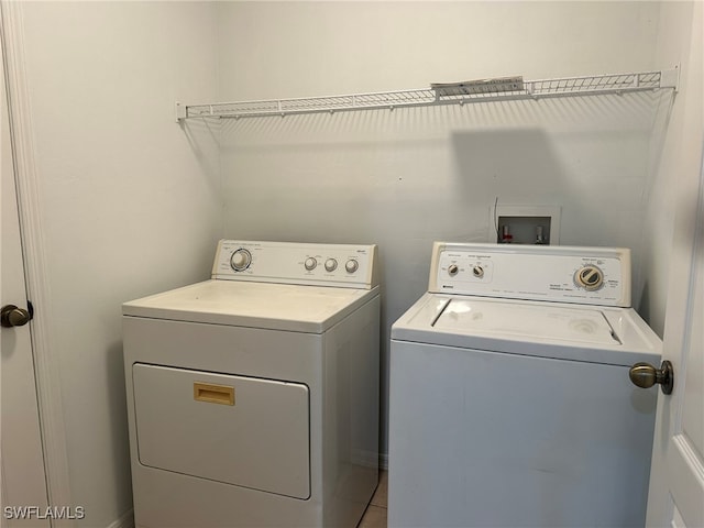 washroom with tile patterned floors and separate washer and dryer