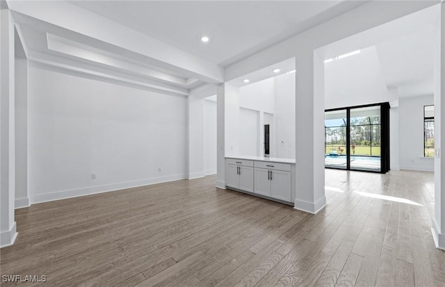14111 Calaveras Ct, Estero, FL 33928 - unfurnished living room with light wood finished floors, baseboards, and recessed lighting