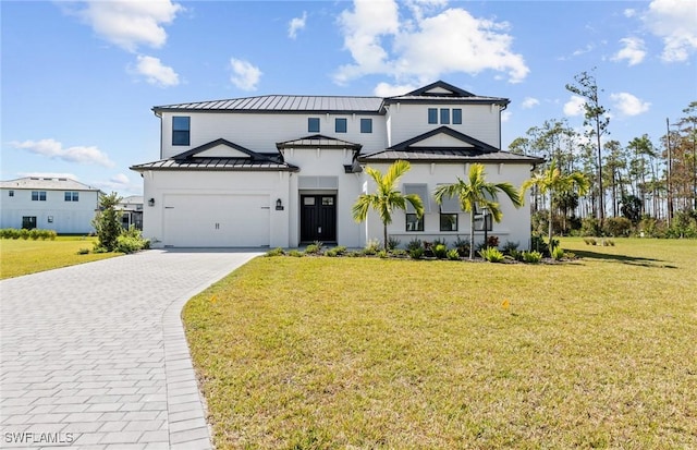 14111 Calaveras Ct, Estero, FL 33928 - view of front of property featuring a standing seam roof, decorative driveway, metal roof, an attached garage, and a front lawn