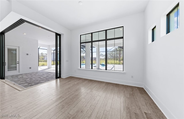 unfurnished room with wood-type flooring