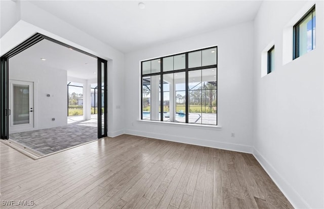 14111 Calaveras Ct, Estero, FL 33928 - empty room featuring wood finished floors and baseboards