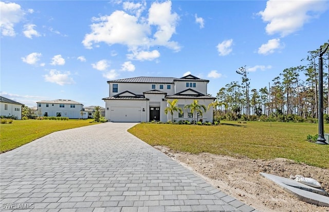 14111 Calaveras Ct, Estero, FL 33928 - view of front of home featuring decorative driveway, a front lawn, an attached garage, and metal roof
