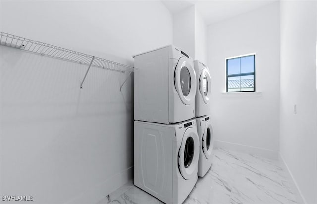 14111 Calaveras Ct, Estero, FL 33928 - laundry area with stacked washing machine and dryer, light marble finish floors, and baseboards