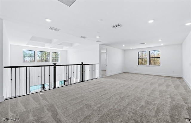 carpeted spare room with a healthy amount of sunlight