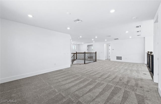 unfurnished living room featuring light carpet