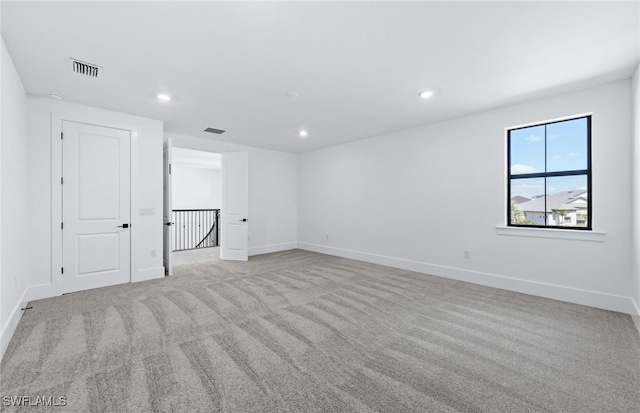 spare room with light carpet