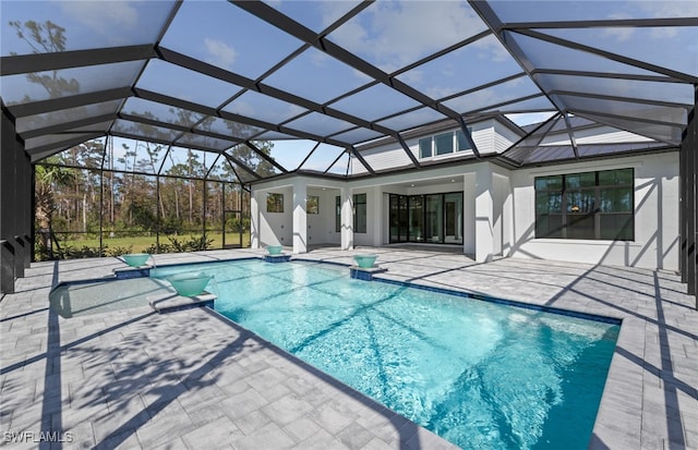 view of pool with a patio area, ceiling fan, and a lanai