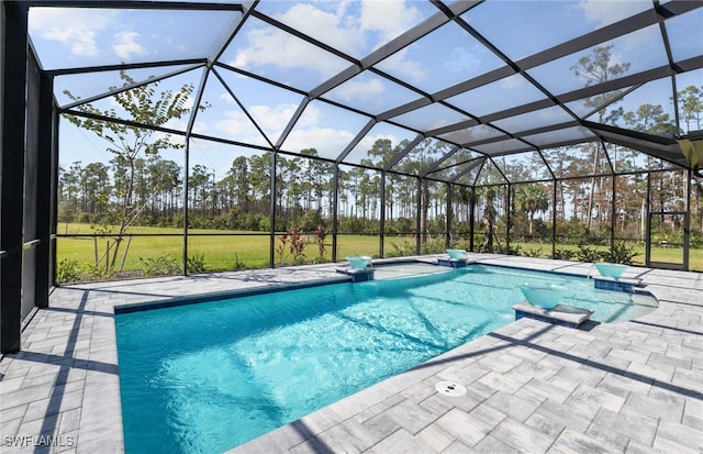 view of swimming pool featuring a patio area and a lanai