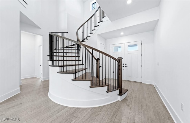 14111 Calaveras Ct, Estero, FL 33928 - stairs featuring wood finished floors, baseboards, a towering ceiling, and recessed lighting