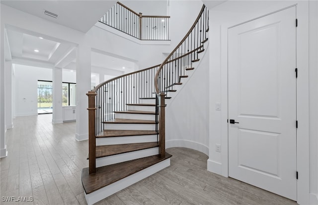 stairs with hardwood / wood-style flooring