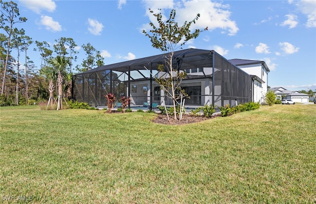 back of house with a lanai and a lawn