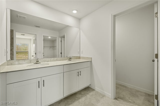 bathroom with tile patterned floors and vanity