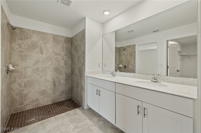 bathroom featuring vanity and tiled shower