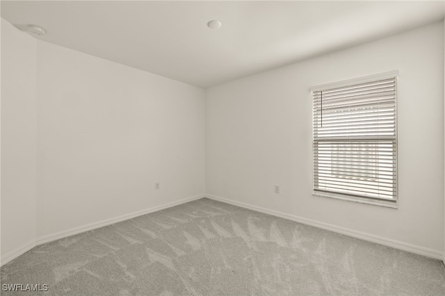 spare room with light colored carpet