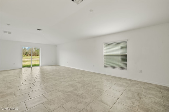 spare room featuring light tile patterned flooring