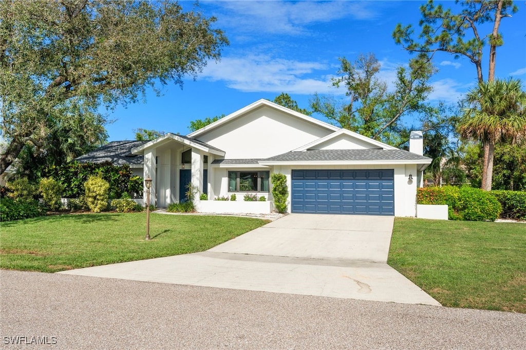 ranch-style home with a garage and a front yard