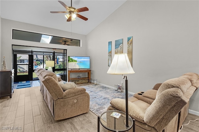 living room with ceiling fan, high vaulted ceiling, and light hardwood / wood-style flooring