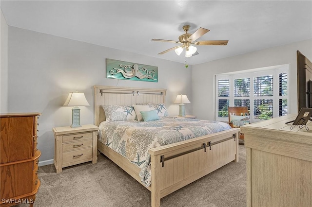 bedroom featuring ceiling fan, baseboards, and light colored carpet