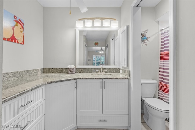 bathroom with vanity, toilet, and ceiling fan