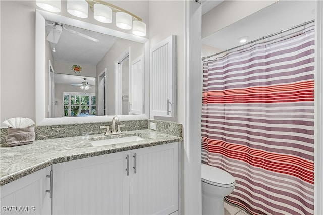 bathroom with ceiling fan, vanity, and toilet