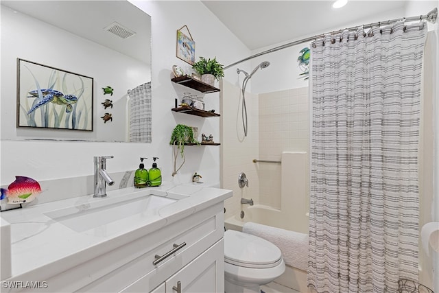 full bathroom with vanity, shower / bath combo, and toilet